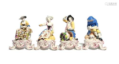 A set of Bow figures of the Rustic Seasons c.1765, each modelled seated on a tall footed base,