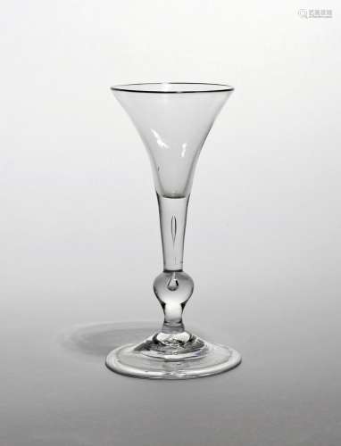 A balustroid wine glass of 'Kit Kat' type c.1740, the drawn trumpet bowl rising from a plain stem