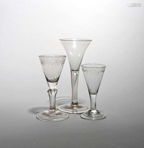 Three wine glasses c.1730-40, one with a drawn trumpet bowl above a plain stem enclosing a long tear