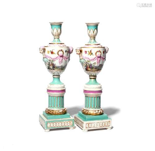 A pair of KPM (Berlin) cassolettes 19th century, the urn forms painted with scenes of courting