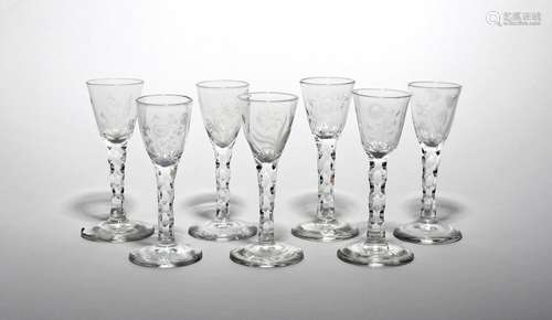 Seven wine glasses c.1770, each rounded funnel bowl engraved with a flower stem including narcissus,