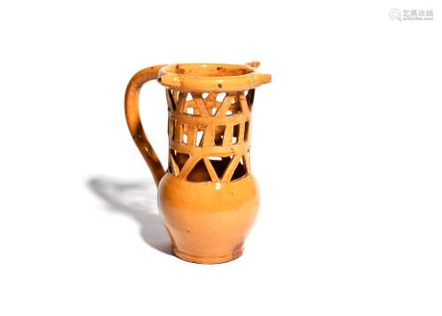 A large slipware puzzle jug 2nd half 18th century, the tall neck pierced with an openwork design