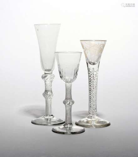 A small wine or cordial glass c.1760, the drawn trumpet bowl engraved with a rose spray above a