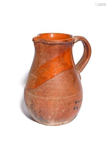 A large earthenware jug c.15th/16th century, the body incised with two horizontal lines, the neck