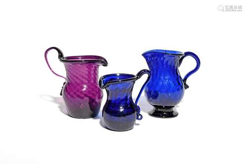 Three coloured glass cream jugs c.1780-1800, one amethyst and spiral-moulded with a folded rim and