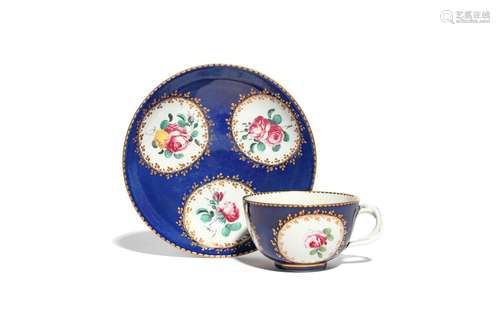 A Doccia cup and saucer c.1760-70, painted with three panels of pink roses reserved within narrow