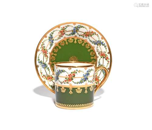 A Sèvres coffee can and saucer dated 1814, painted with overlapping garlands of red and blue flowers