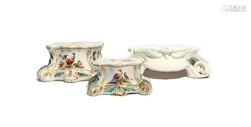 Two Derby figure stands c.1760-65, painted with panels of exotic birds alternating with moths and