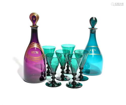 Two coloured glass decanters and stoppers c.1800, one amethyst, the other green, gilded with the