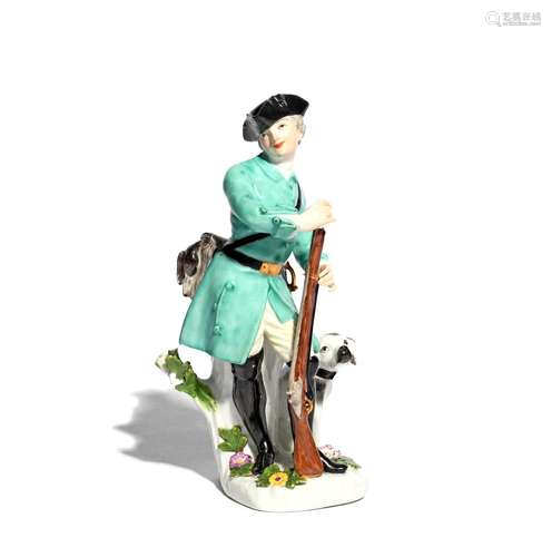 A Meissen figure of a huntsman c.1745, modelled by J J Kändler, standing and holding the butt of his