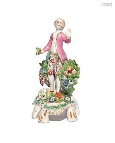 A rare Bow miniature figure of a boy c.1765, standing with his left hand outstretched, holding a