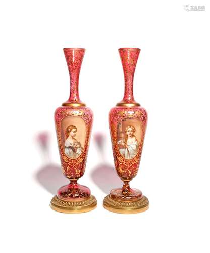 A tall pair of Bohemian glass vases late 19th century, each painted with the portrait of a young