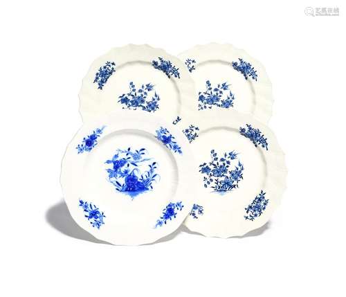 Four Tournai plates c.1775-90, three decorated in blue with a bird in flight above flowering