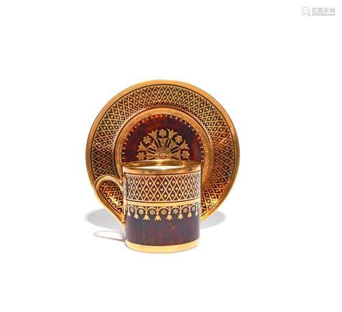 A Sèvres coffee can and saucer dated 1818, decorated with a formal gilt chequered design