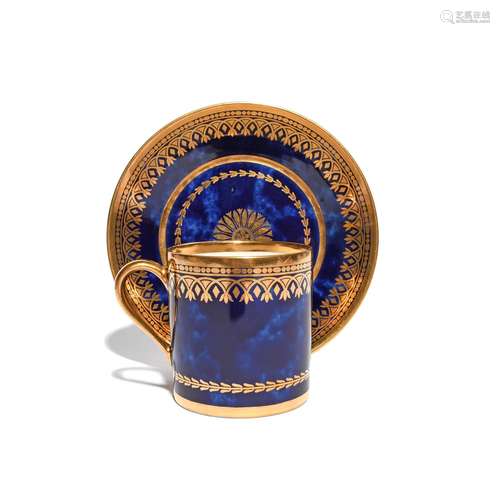 A Sèvres coffee can and saucer dated 1818, decorated with formal gilt borders and a narrow husk band