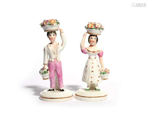 A pair of Staffordshire porcelain figures of children 19th century, possibly Rockingham, each