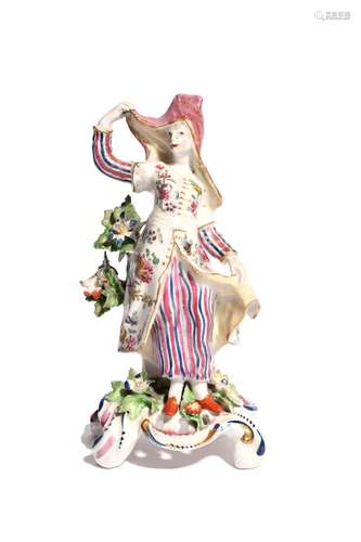 A Bow figure of a Levantine lady c.1760, after a Meissen original, standing and wearing a flowered