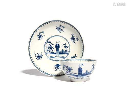 A Worcester blue and white teabowl and saucer c.1765, painted with the Waiting Chinaman pattern, the