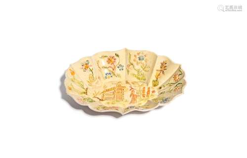 A Staffordshire salt-glazed small dish or tray c.1750, moulded with a Chinese figure standing before