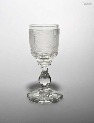 A Bohemian glass goblet dated 1845, the thick bowl deeply engraved with a continuous scene of a