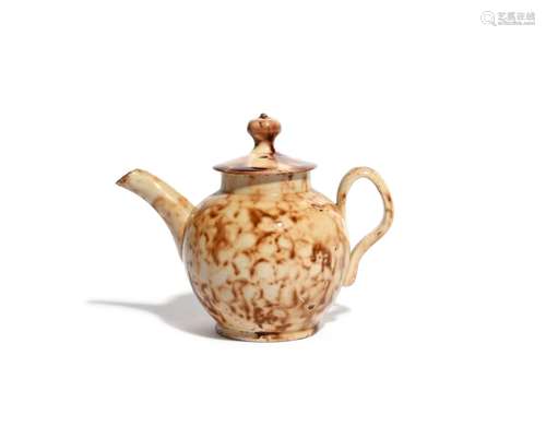 A miniature creamware teapot and cover of Whieldon type c.1760, the small globular body decorated in