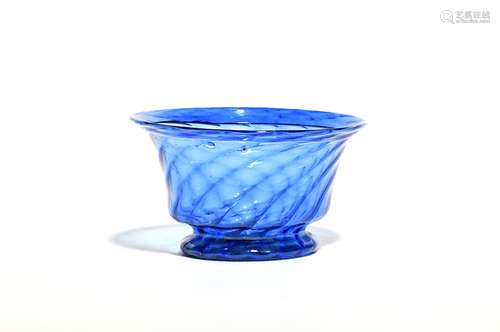 A small blue glass bowl c.1800, spiral moulded with a folded everted rim, raised on a low circular