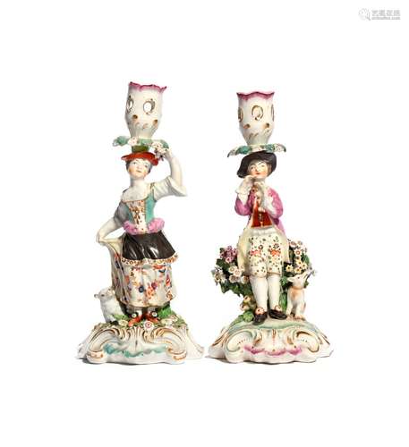 A matched pair of Derby candlestick figures c.1765, of a young shepherd playing the flageolet