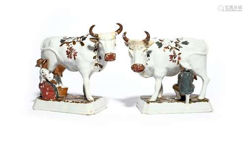 A pair of Delft cows 18th/19th century, each standing four square on a rectangular base with head