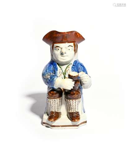 A Skew Face toby jug c.1800, modelled in typical fashion with a foaming jug of ale on one