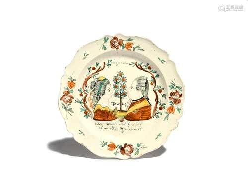 A Dutch-decorated creamware plate c.1767-75, painted with profile portraits of William V of Orange