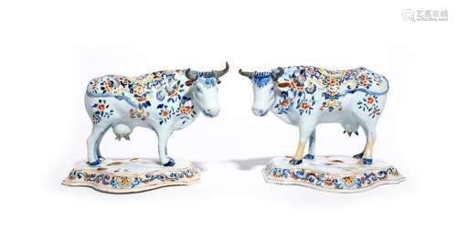 A pair of Delft cows probably 19th century, each standing four square on a shaped base with head