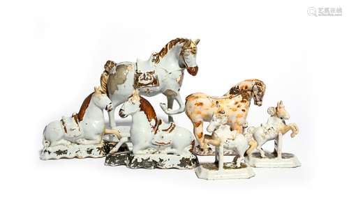 Two pairs of Delft horses mid 18th century, the small pair modelled jumping over fences, saddled and