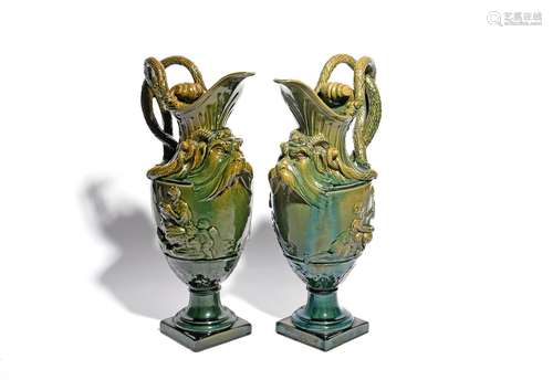 A pair of large glazed stoneware ewers 19th century, probably French, after a design by Clodion,