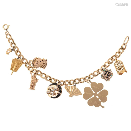 A 10K Charm Bracelet with Nine Charms in Gold