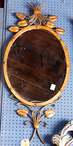 A neoclassical style oval mirror