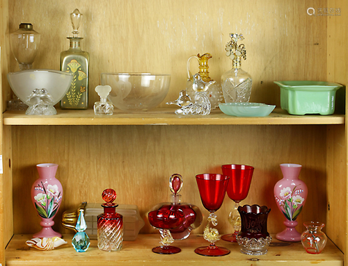 Two shelves of cut glass and colored glass tablewares