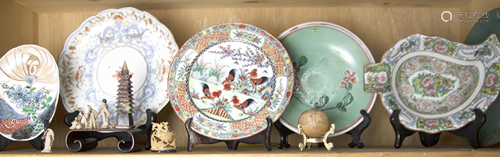 Shelf of Asian dishes and other decorative arts