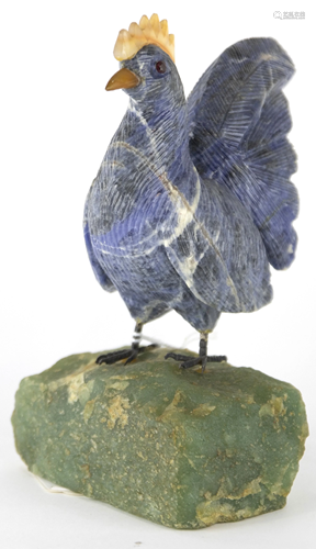 Art glass and rock sculpture of a rooster