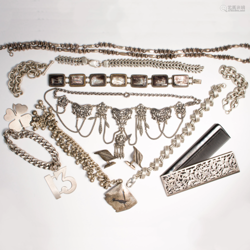 A group of silver jewelry and accessories