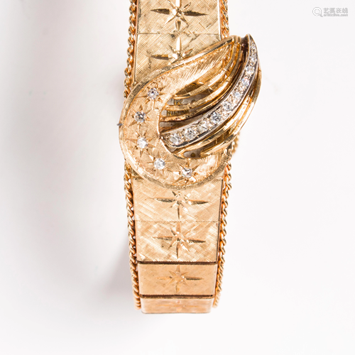 A fourteen karat gold and diamond conealed wristwatch