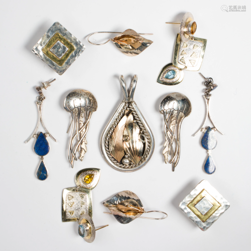 A group of silver earrings and a pendant