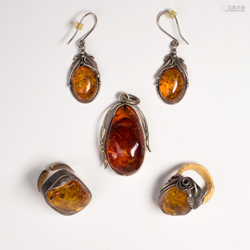 A group of amber and silver jewlery