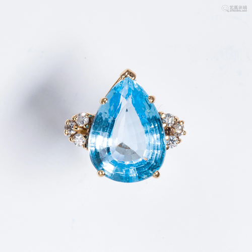 A blue topaz, diamond and fourteen karat gold ring