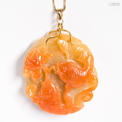 A carved orange jade and fourteen karat gold pendant