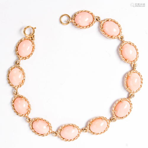 A coral and fourteen karat yellow gold bracelet