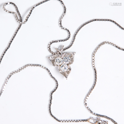 A diamond and fourteen karat gold pendant necklace