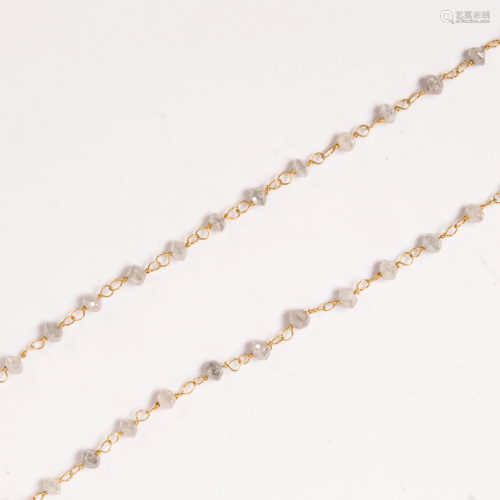 A diamond bead and fourteen karat gold necklace