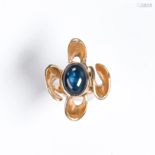 A synthetic star sapphire and gold plated ring