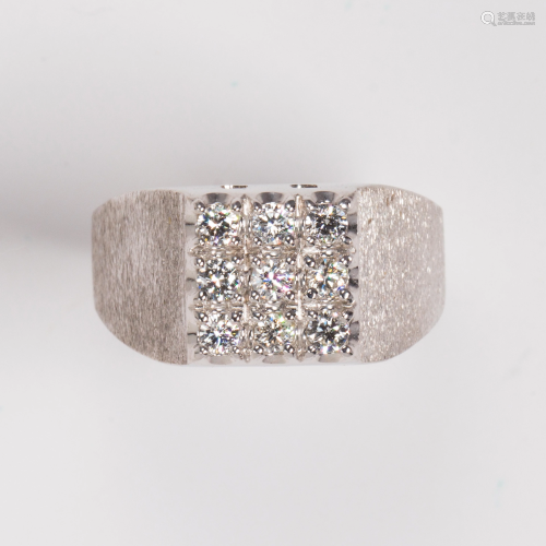 A diamond and fourteen karat gold white ring