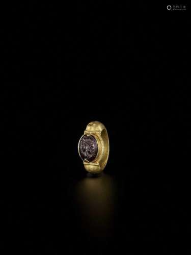 A Burmese Gold Ring With A Dar…